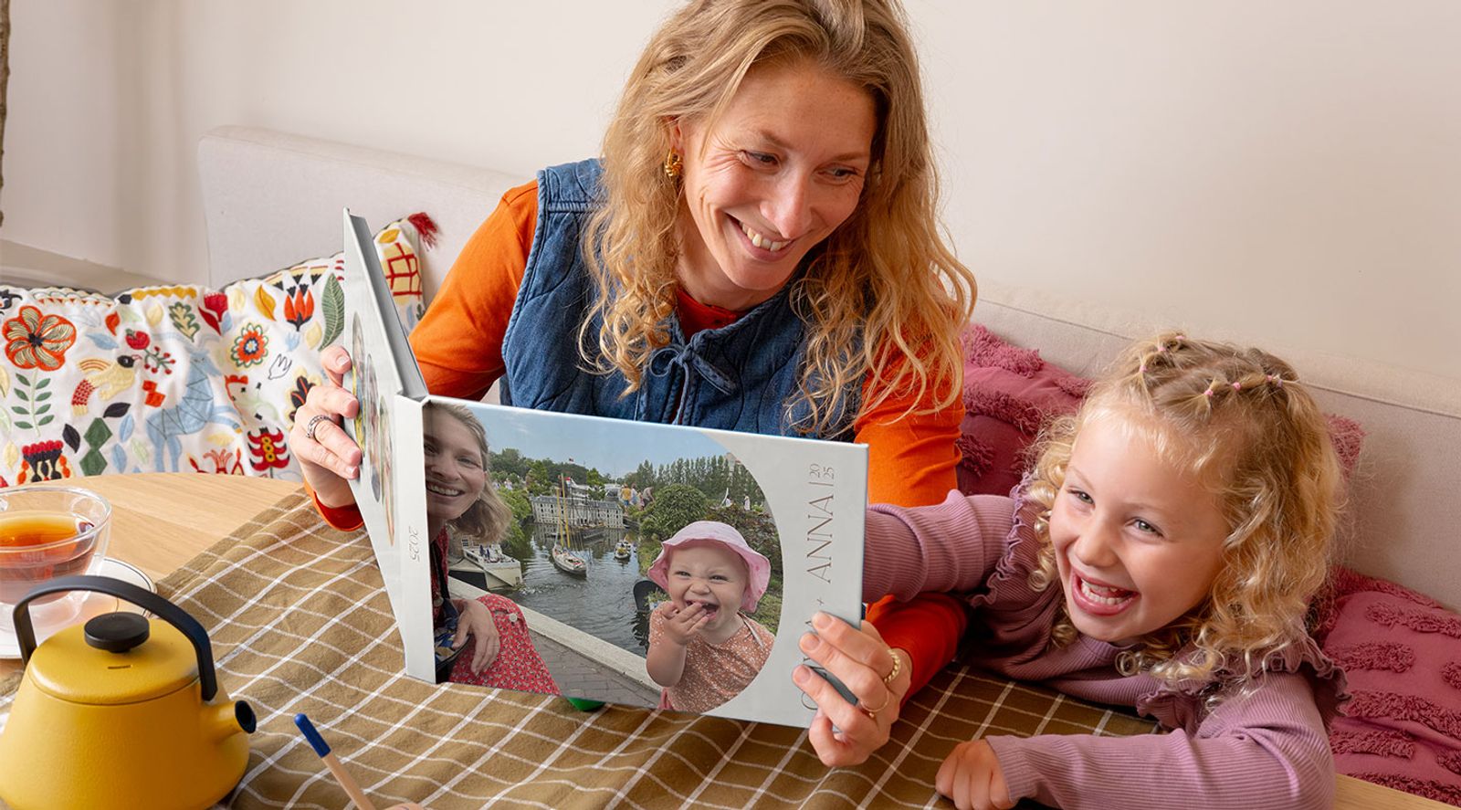 A Photobox photo book shown open with printed family and travel photos